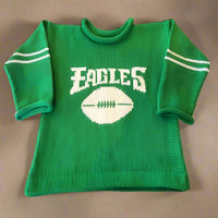 Personalized Philadelphia Eagles baby sweater in green and white with custom name, laid flat on a soft background, perfect for NFL game day
